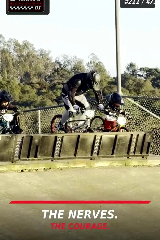 Young riders ready at a BMX starting gate